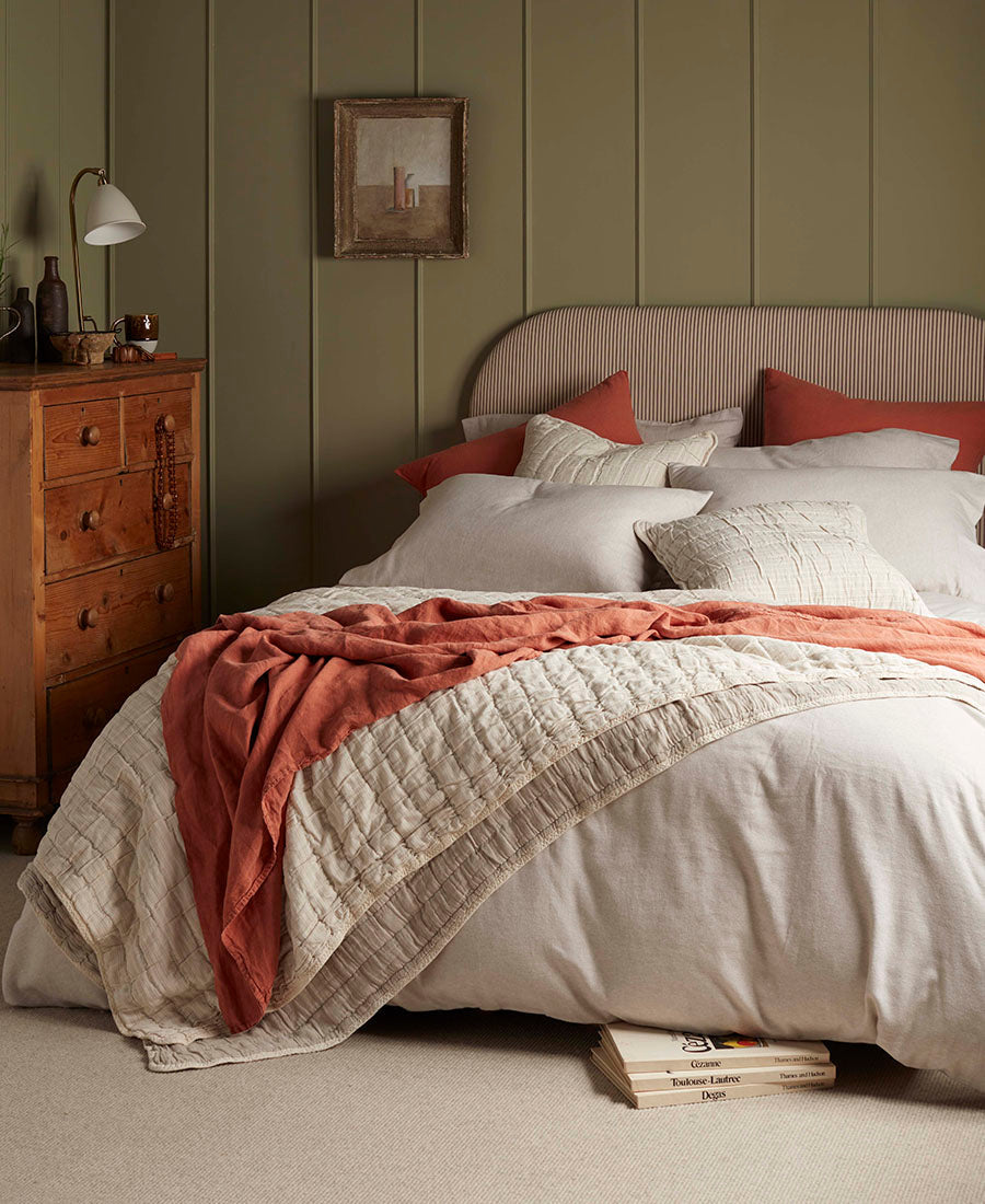 Brushed cotton bedding is layered with throws.