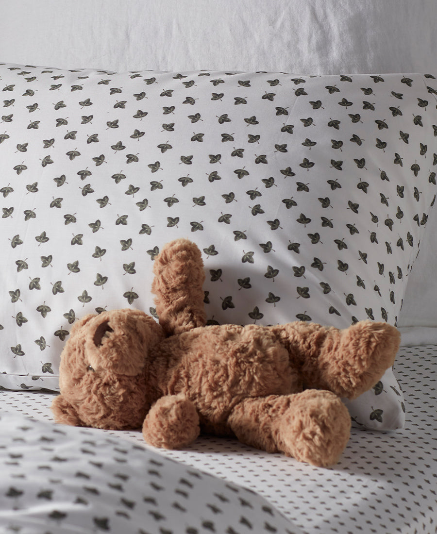 child bed with teddy on