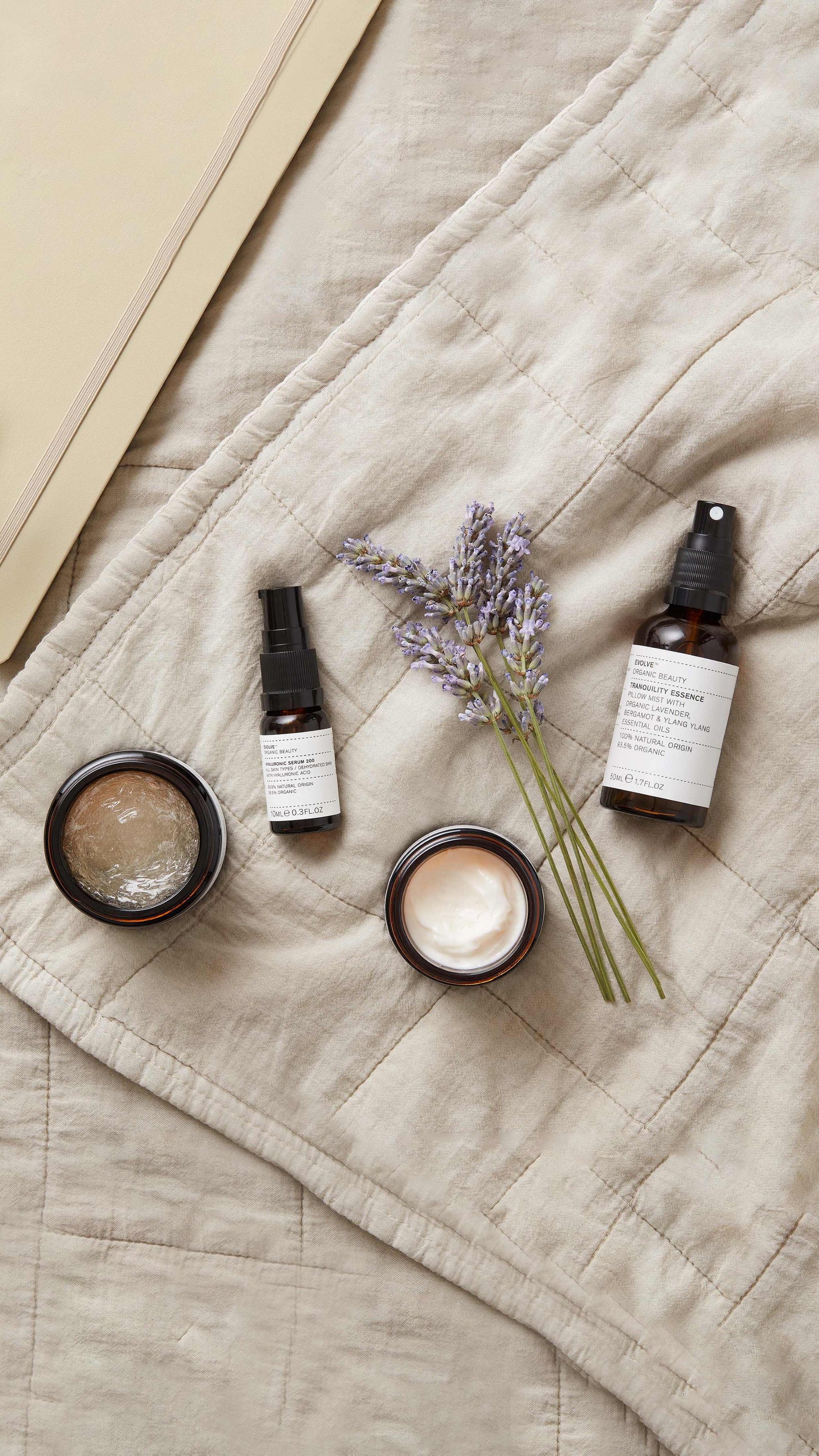 Evolve Beauty Skincare laid on a bed.