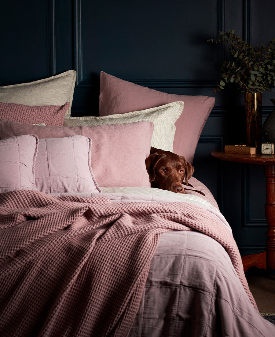 A bed with our Vintage Rose 100% Linen Bed Linen with our vintage rose 100% Cotton waffle throw and cushion covers . Along with our Vintage Rose Finn 100% Cotton Quilted  rectangle cushion cover.